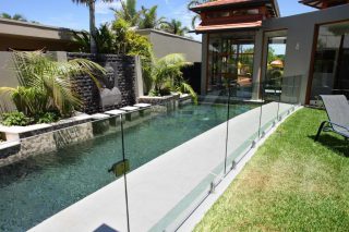 Pool in asian style with glass pool fencing