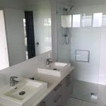 Bathroom with frameless shower screen and mirror